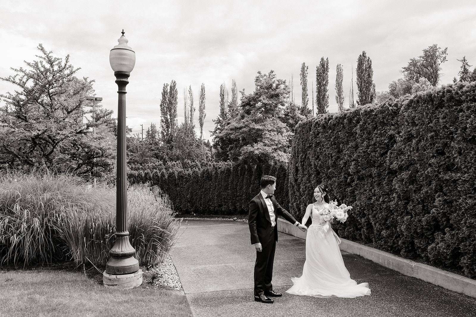 bride and groom walking through garden
