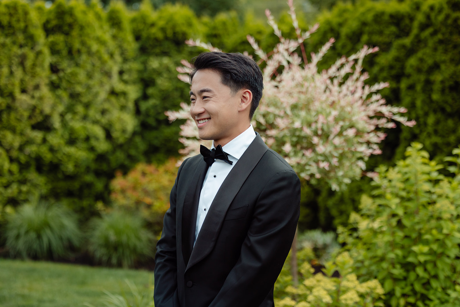 groom looks at bride walking down aisle